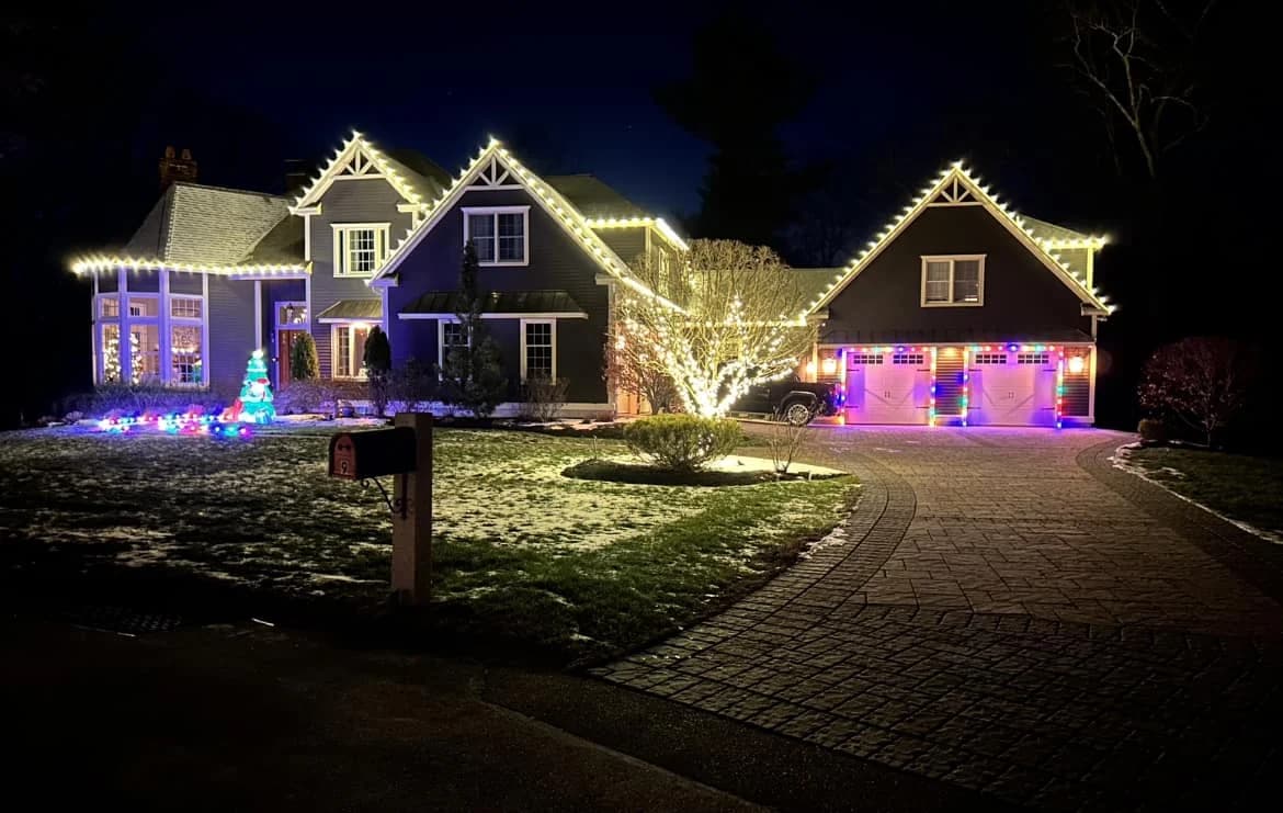 C7 and C9 permanent holiday lights outlining a residential roofline and landscape