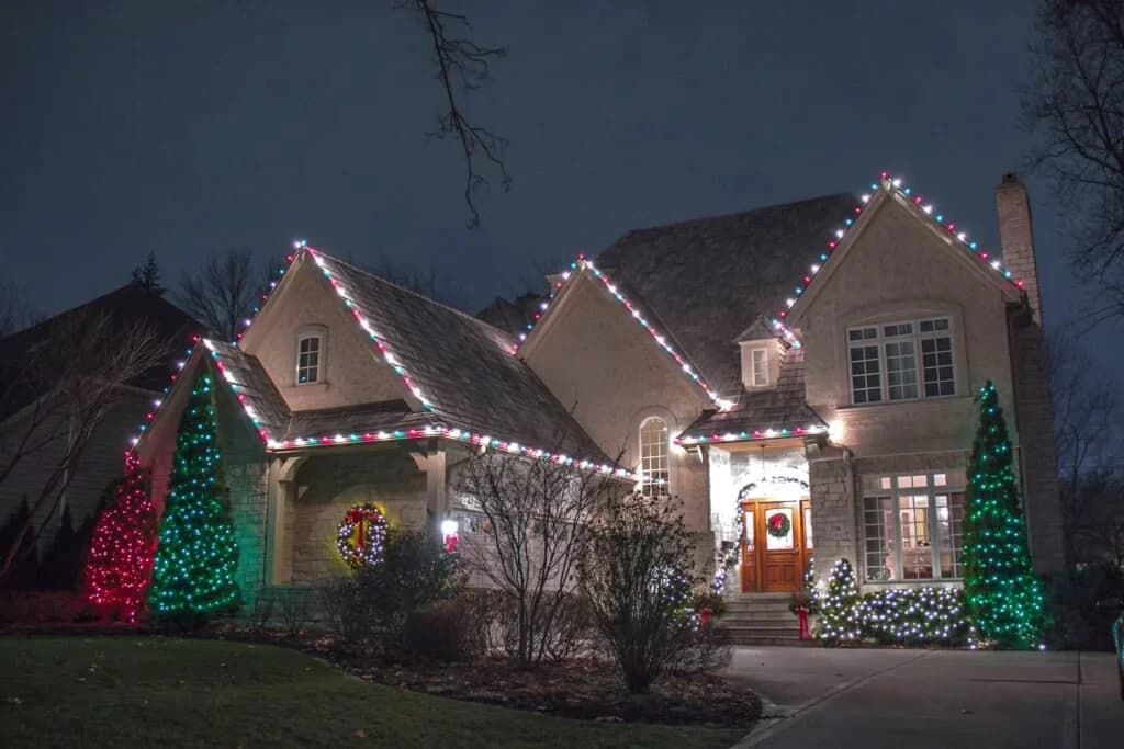 Residential C7 and C9 Christmas lighting installed on rooflines and trees